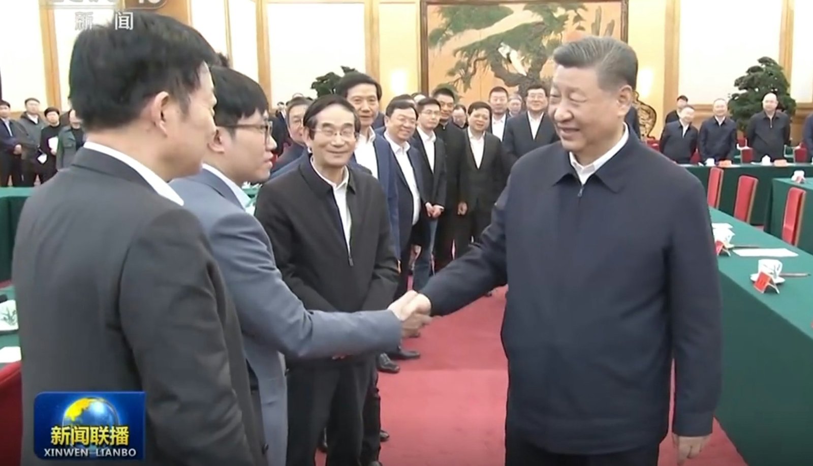 Chinese President Xi Jinping smiling and shaking hands with a representative at a conference, with other attendees looking on in the background. A CCTV "Xinwen Lianbo" logo is visible in the bottom left corner.A CCTV "Xinwen Lianbo" news broadcast screenshot showing Xi Jinping in a dark jacket shaking hands with Liang Wenfeng, founder of DeepSeek. They stand on a red carpet in a formal conference room surrounded by other attendees. Chinese President Xi Jinping smiling and shaking hands with a representative at a conference, with other attendees looking on in the background. A CCTV "Xinwen Lianbo" logo is visible in the bottom left corner.A CCTV "Xinwen Lianbo" news broadcast screenshot showing Xi Jinping in a dark jacket shaking hands with Liang Wenfeng, founder of DeepSeek. They stand on a red carpet in a formal conference room surrounded by other attendees.