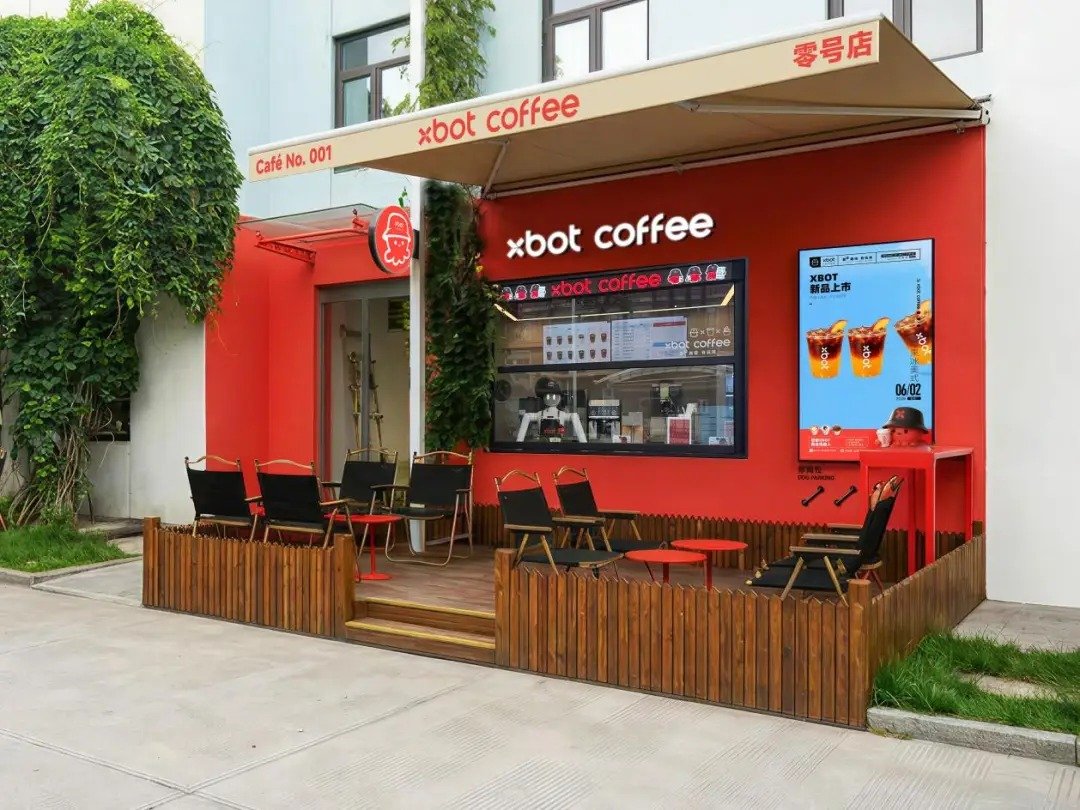 XBOT C3 coffee robot with a robotic arm making coffee inside a two square metre unit