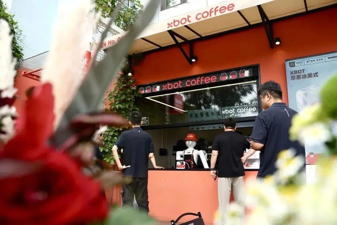 Keenon humanoid robot making coffee at a Nowwa Coffee pop-up store in Shanghai