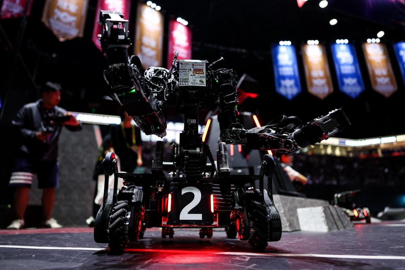 Engineering robot with a multi-degree-of-freedom arm grasping an energy unit at RoboMaster 2026