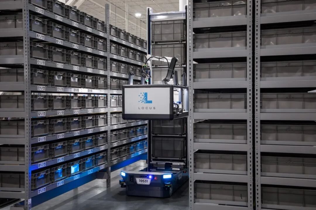 Warehouse associate working alongside a Locus AMR