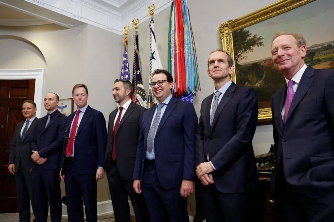 Technology executives standing in a formal room with flags in Washington