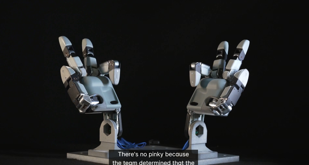 Four-fingered Atlas hand gripping an industrial tool with a trigger