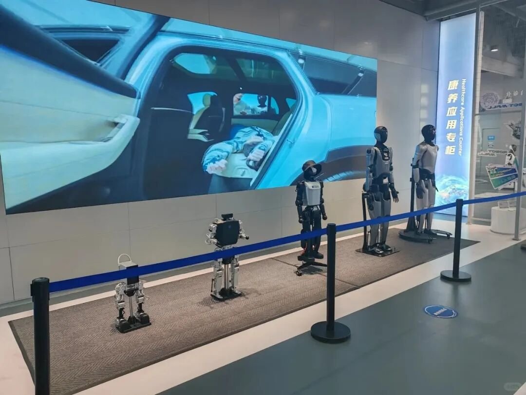 Visitors watching a humanoid robot performance at a commercial venue