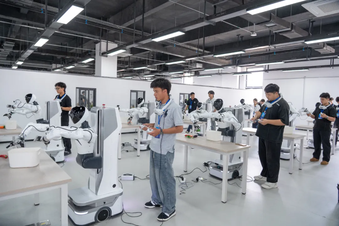 Trainees operating humanoid robots in a robot data collection laboratory
