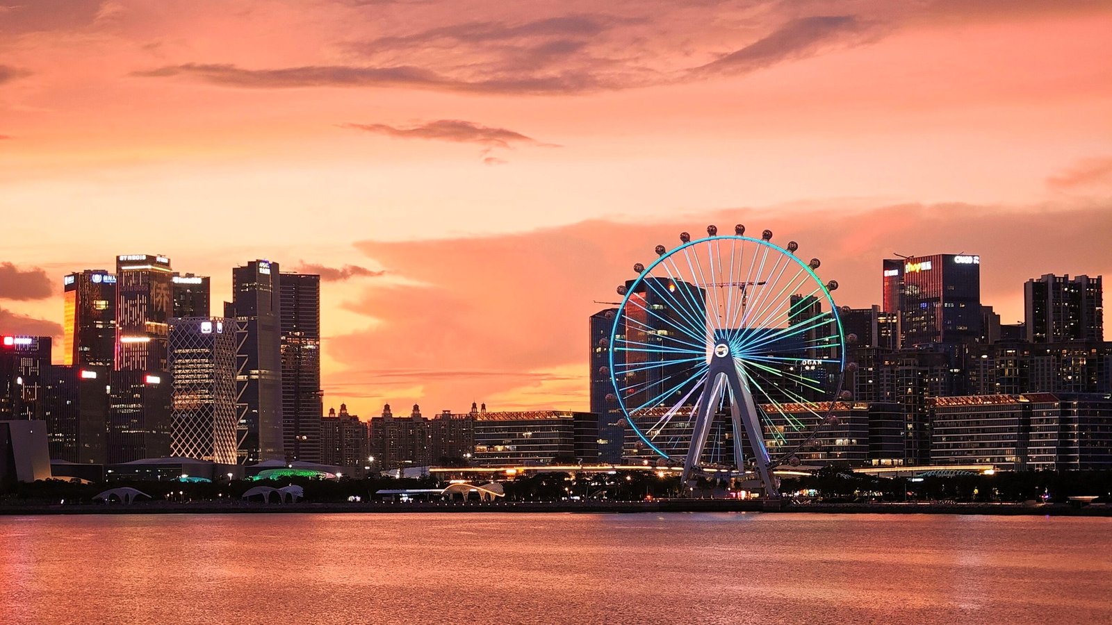 The Bay Glory ferris wheel at dusk, with the Bao'an skyline behind it
